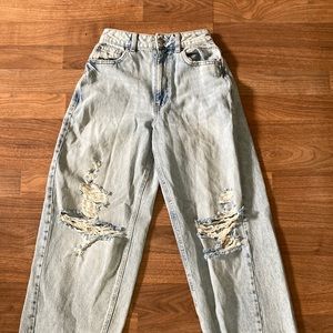 Light blue high rise jeans with holes in the knees